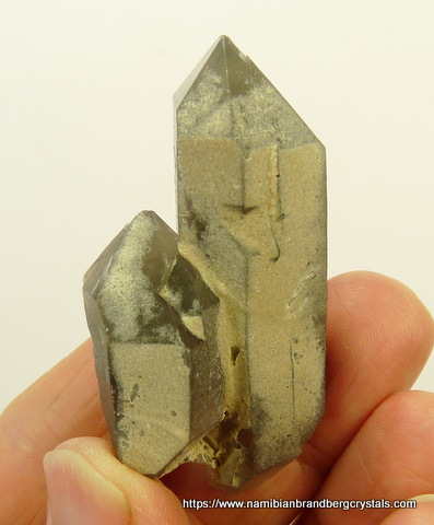 Quartz crystal group with hematite inclusions and partial coating