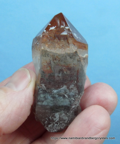 Double terminated quartz crystal with hematite inclusions
