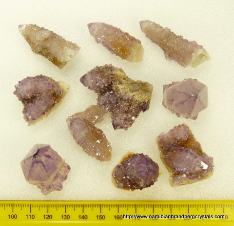 Ten cactus quartz specimens in varying shades of amethyst