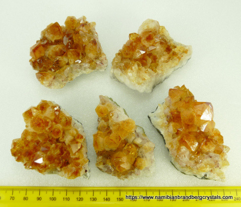 Five pieces of drusy 'citrine' coloured quartz crystals on matrix