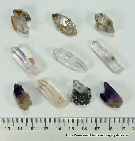 Ten small quartz specimens, including amethyst and negative crystal inclusions