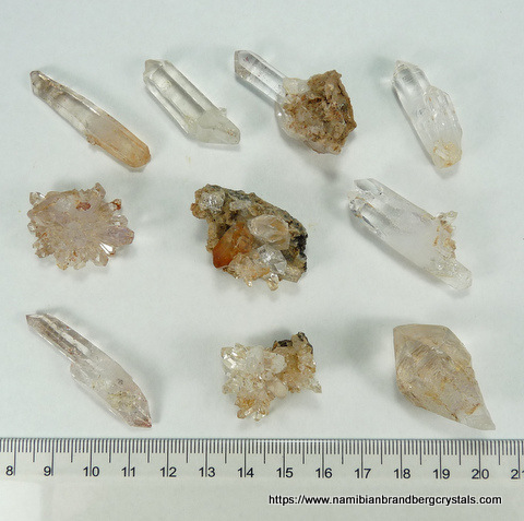 Ten small quartz specimens, including amethyst and negative crystal inclusions