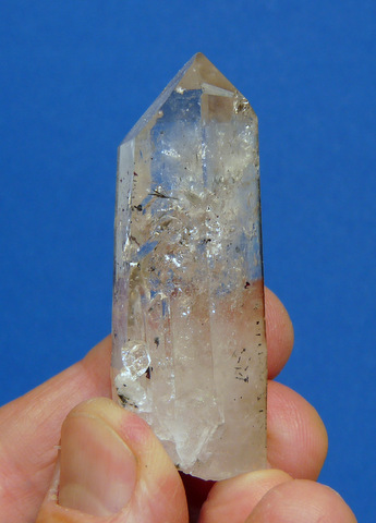 Clear quartz crystal with hematite specks and threads