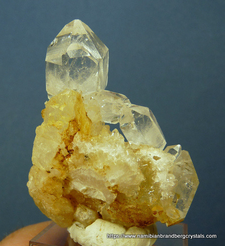 A few double terminated and other quartz crystals on matrix