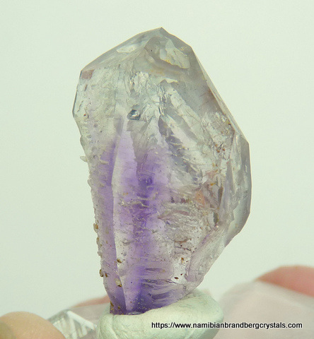 Unusually shaped window quartz crystal with amethyst core