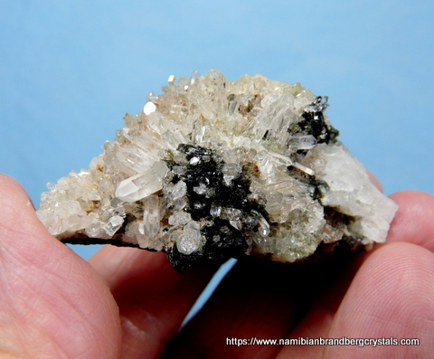 Epidote, small quartz cystals and bits of prehnite, on matrix