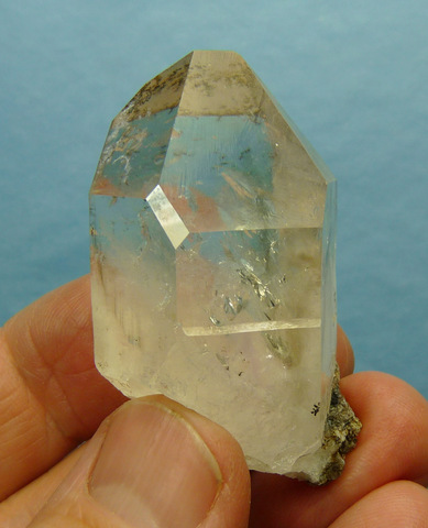 Quartz crystal with minute dendrites on some surfaces