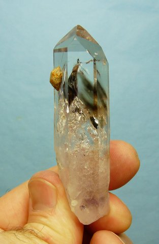 Lovely quartz crystal with some light smoky phantoms in its upper half and lovely gas inclusions