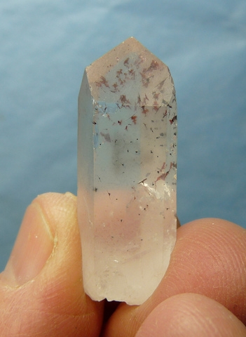 Harlequin quartz crystal with epidote and hematite inclusions
