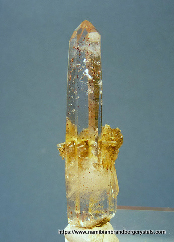 Quartz crystal with red hematite inclusions