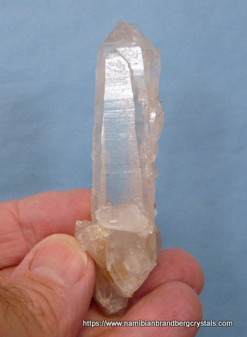 Double terminated quartz crystal with inclusions