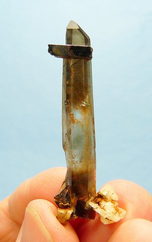 Slender smoky quartz crystal with aegirine and feldspar