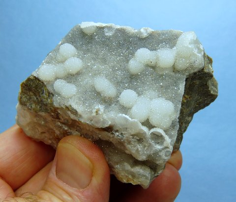 Balls of smithsonite on smithsonite crystals, on rock matrix