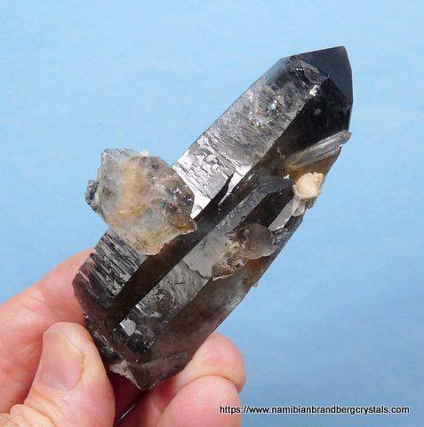Smoky quartz crystal with black needle-like inclusions