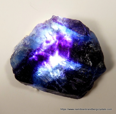 Banded piece of fluorite seen with light behind it